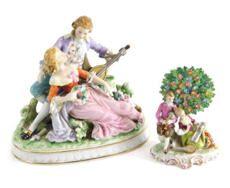 A Continental porcelain figural group of a lady and gentleman, he playing flute she holding garland, in a naturalistic settin