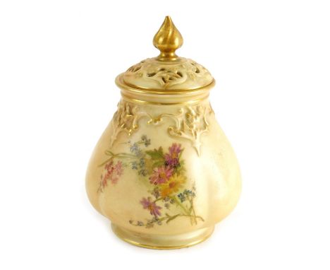 A 20thC Royal Worcester porcelain potpourri vase, with pierced lid, shaped body, hand painted with flowers on a circular foot