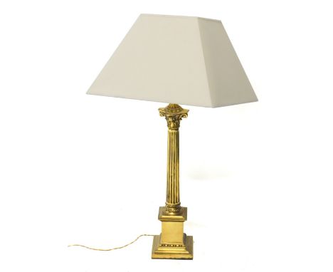 A brass table lamp, with classical column, on stepped base with modern electric fitting and cream shade, 82cm high. Buyer Not