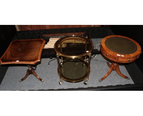 A reproduction Regency style pedestal drum table; another reproduction Regency style tripod table; and a brass two-tier circu