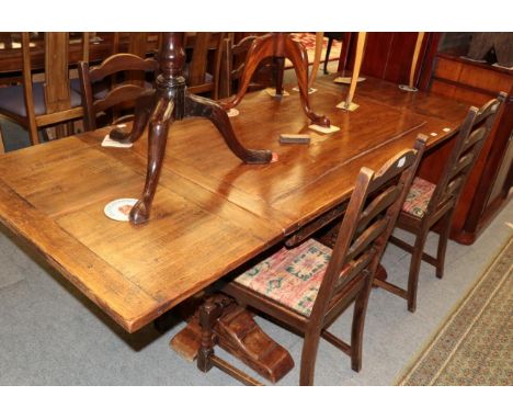 A carved oak drawer leaf refectory style table and four ladder back chairs 