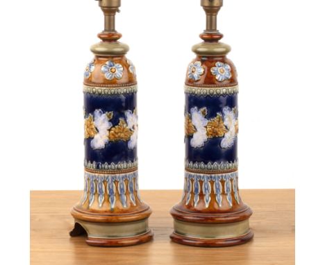 Attributed to Doulton Lambeth pair of lamps, of cylindrical form, imperial blue ground, decorated with flowers and foliage, e