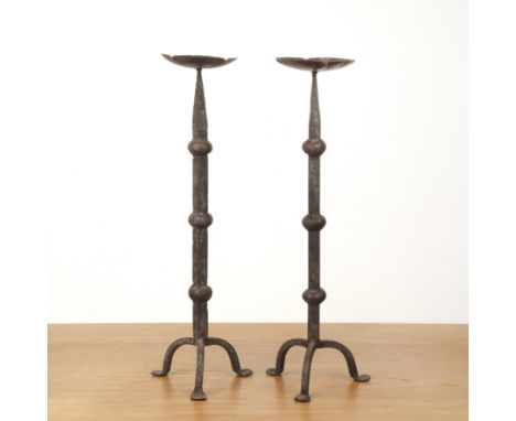 Pair of pricket candlesticksiron, tripod base, standing on pad feet, 56cm high (2)   At present, there is no condition report