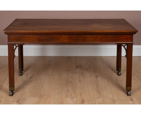 Chippendale style mahogany serving table with square section legs raised on brass caps and castors, 137cm wide x 65cm deep x 