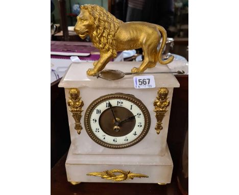 A Victorian white alabaster clock surmounted with a lion 