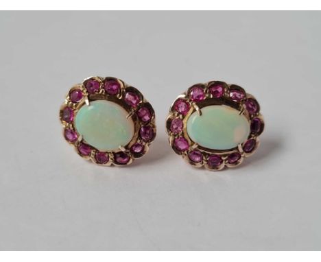 A PAIR OF ANTIQUE GOLD MOUNTED OPAL AND RUBY OVAL CLUSTER EARRINGS 