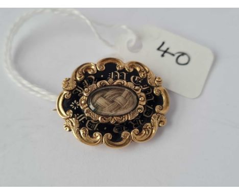 An 1833 Regency gold and enamel mourning brooch