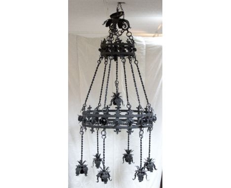An Italian wrought iron seven-light chandelier, with two pierced and applied tiered hoops suspending seven flowerhead type dr