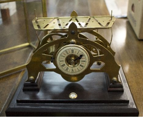 A Congreve type skeleton clock with fusee movement and enamel chapter ring in a glazed case, 27cm wide   Condition Report:  T