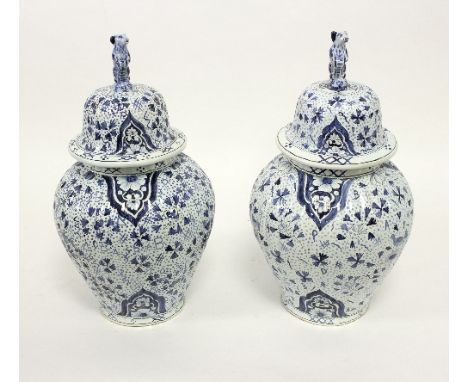 A pair of modern blue and white Delftware jars and covers, oviform with floral decoration and dog finials, 41cm high