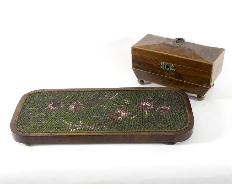 A 19th Century mahogany tea caddy with satinwood stringing and brass floral loop finial, the fitted interior missing the glas