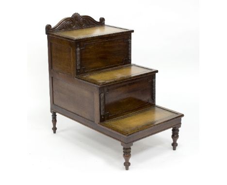 A George IV step commode of three steps with tooled leather inset, pull out commode and hinged top on turned legs, 48cm wide 