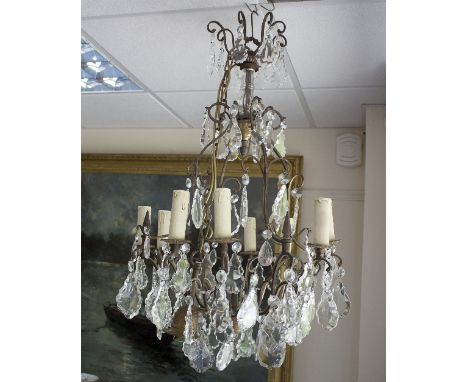 A twelve-branch eight-light chandelier hung with glass drops, 88cm high/see illustration