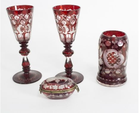 A group of Bohemian clear and ruby flash glass comprising a pair of goblets, an oval box engraved with a townscape titled 'Ga