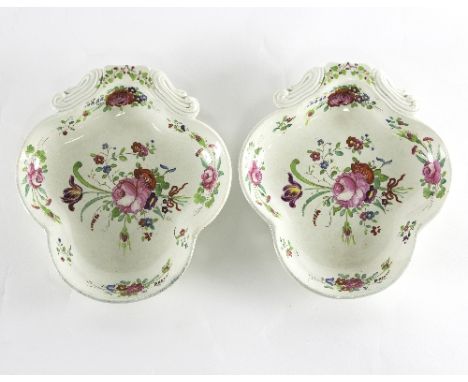 A pair of 19th Century enamelled pearlware shell shaped dishes, painted floral decoration, monogrammed MH with label to the r