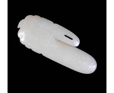 A Chinese white jade pendant, of stylised oval form, carved with Greek key type motifs and scrolls to front and inscribed wit