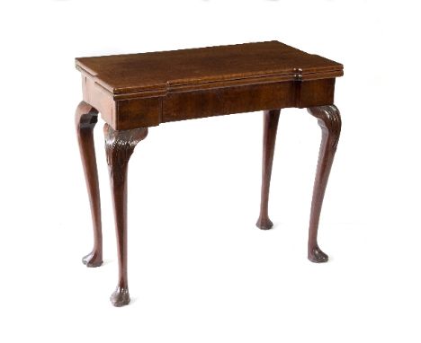 A George III mahogany card table, the top with outset corners, and raised on acanthus carved cabriole legs and trefid feet, 8