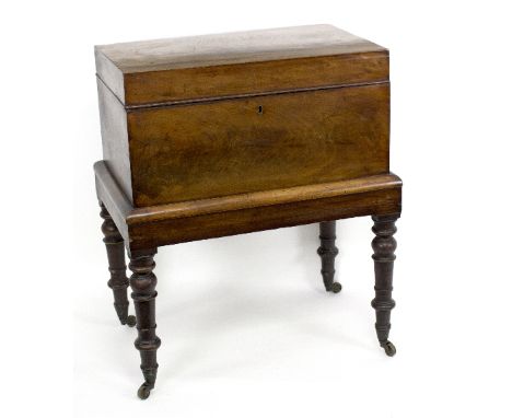 A George IV mahogany decanter box, with hinged cover on turned legs with castors, 57.5cm wide