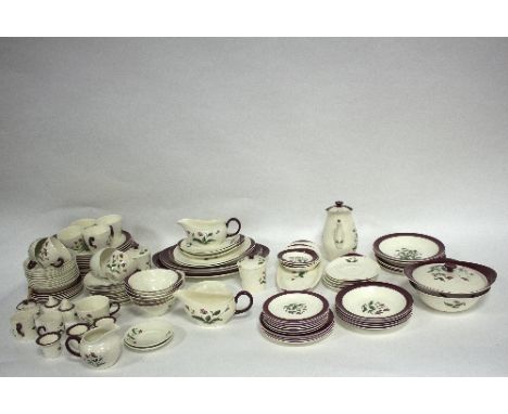 A Wedgwood 'Ruby Mayfield' pattern part dinner service, printed with flowers within a dark pink border, printed and impressed