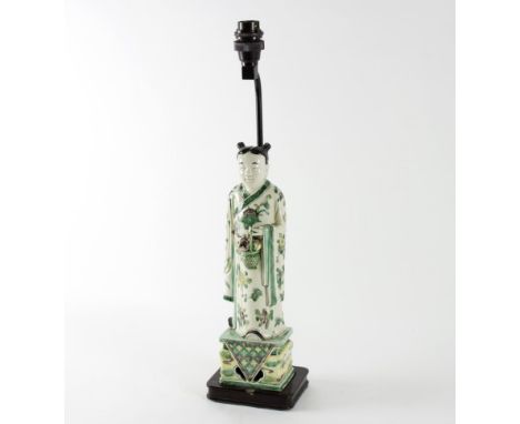 A Chinese porcelain figure of an immortal, late 19th/early 20th Century, with basket of flowers wearing a floral robe, 32cm h