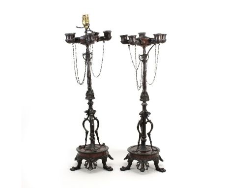 A pair of French Empire style bronze table lights, each set five sconces, the columns entwined and with mask heads on tripod 
