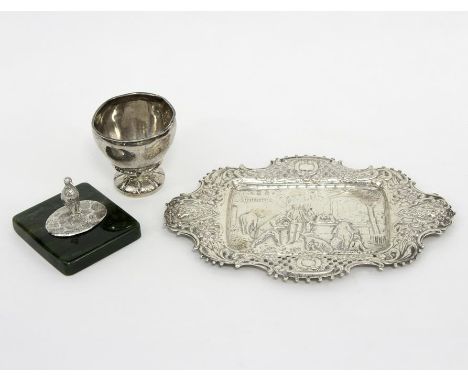 A Continental white metal tray, import marks depicting figures playing bowls, 22.5cm wide, a white metal cup, lacking handle 