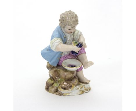 A Meissen figure of a young vintner, mid 19th Century, incised marks, 11cm high