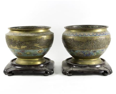 A pair of Chinese cloisonné footed bowls each with a wide band of repousse decoration depicting figures in a landscape within