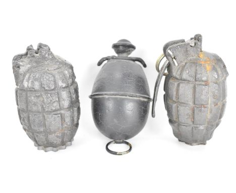 A group of three inert grenades to include a First World War Mills bomb marked 1917 and one similar together with a WWII Germ