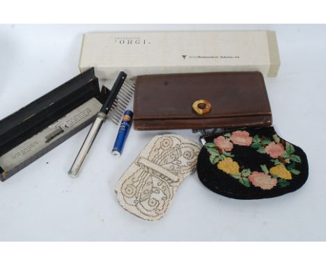 A collection of vintage ladies accessories to include a good leather clutch bag, beadwork purses, electric comb and a Japanes