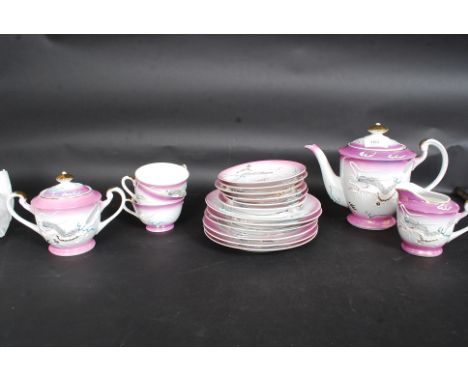 A good early 20th century Japanese export  Geisha tea service in unusual colours and decoration complete with the teapot , cu