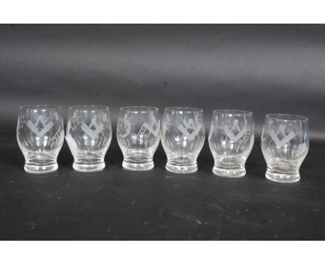 A set of six Masonic firing glasses, engraved with the square and compass, sun, trowel and other Masonic imagery / symbols