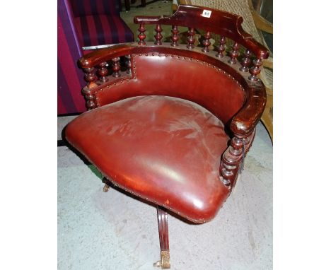 A Victorian mahogany framed office swivel armchair, with spindle back, on a tripod base.