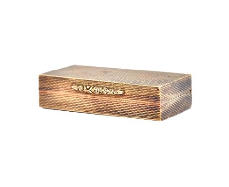 A 9ct gold rectangular hinge lidded pill box, the exterior with engine turned decoration, London 1973, size 4cm x 2cm, weight