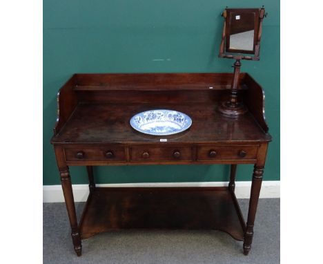 An early 19th century mahogany washstand, with galleried back and inset ceramic wash bowl, over a pair of frieze drawers on t