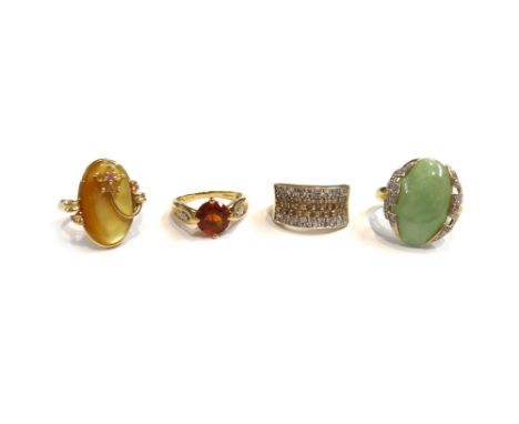 A 9ct gold, jade and diamond set ring, mounted with the oval cabochon jade between diamond set shoulders, a 9ct gold and vary