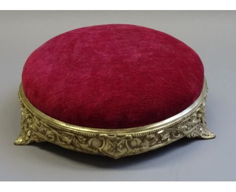 WT & S; a late Victorian gilt metal framed circular footstool, with dragon relief decoration, impressed registration lozenge,