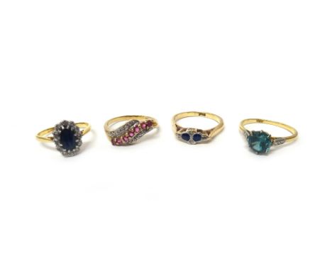 A gold ring, claw set with a circular cut blue zircon, detailed '18ct', a gold, sapphire and diamond set six stone ring, deta