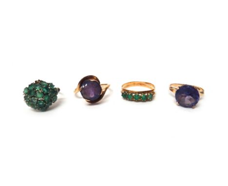 Two gold and mauve gem set solitaire rings, a gold and green gem set five stone ring and a gold and green gem set cluster rin