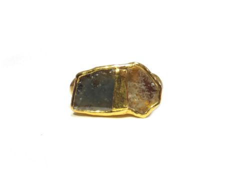 A gold and diamond ring, in an abstract design, mounted with two irregularly flat cut diamonds, possibly Indian, ring size L,