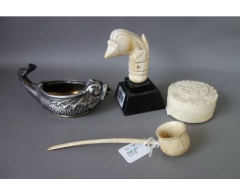 An early 19th century carved ivory kris handle, 7cm long, a foliate carved ivory circular pot and cover, 6.5cm diameter, a ca