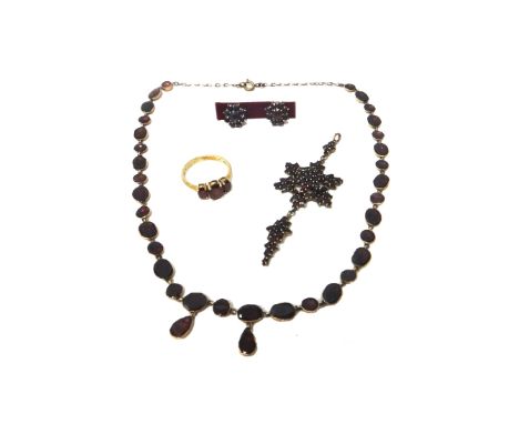 A flat cut garnet set necklace, a Bohemian garnet set pendant, in a hexagonal design, a 9ct gold and garnet set three stone r