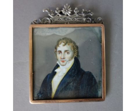 Early 19th century English School, a portrait miniature on ivory of a young man in blue coat, with black collar and gilt butt