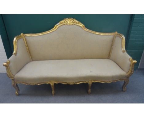 An 18th century style gilt framed three seat sofa, with shell carved crest and serpentine seat, on scroll supports, 199cm wid