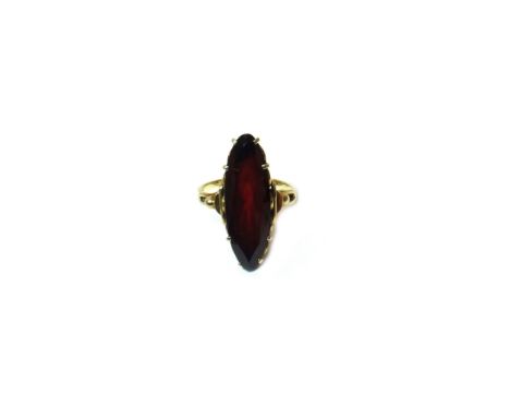 A garnet set single stone ring, claw set with a marquise shaped garnet, between beaded shoulders, ring size L.