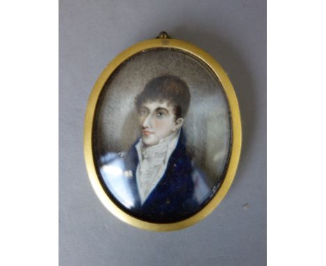 An early 19th century English School portrait miniature on ivory, of a young gentleman wearing a dark blue coat, white shirt 