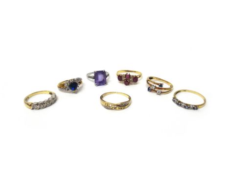 An amethyst and diamond ring, claw set with the cut cornered rectangular step cut amethyst between diamond set four stone sho