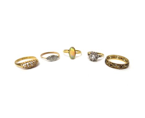 A gold ring, claw set with an oval opal, an 18ct gold and diamond set five stone ring, a gold and platinum, diamond set singl