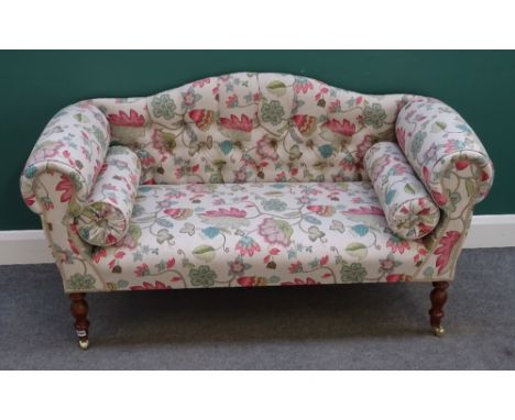 A modern hump back sofa, of small proportions, with floral upholstery, rollover arms on turned supports, 140cm wide x 78cm hi