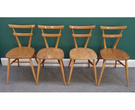 Ercol, a set of four beech and elm, green dot, stacking chairs, 40cm wide x 79cm high.